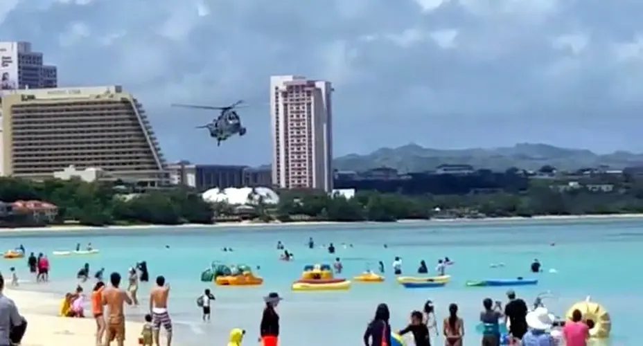 Royal Canadian Navy chopper flies low over Tumon Bay