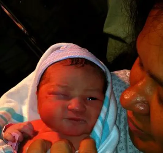 Baby New Year born a minute after midnight