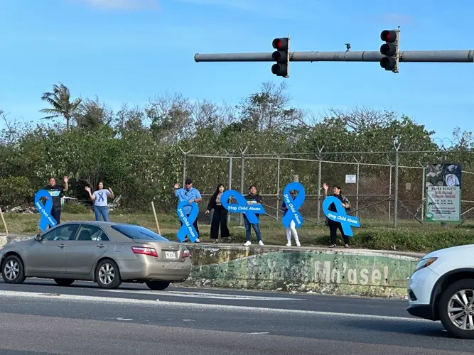 Dozens wave to kick off Child Abuse Awareness and Prevention Month