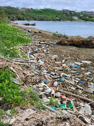 Encampment has grown along the shoreline, littered with trash