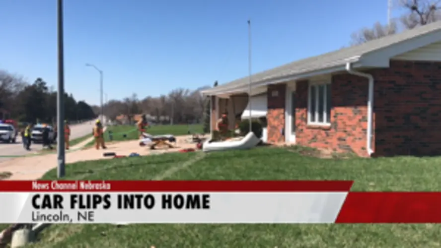 A car crashes and then flips into a Lincoln home