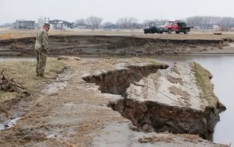Floodwaters leave National Guard's top training camp a wasteland of sand and broken trees