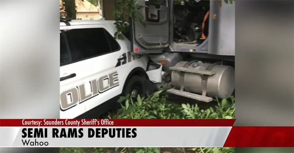 Authorities say man arrested after ramming 2 police vehicles