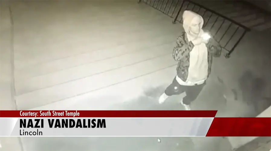 Surveillance video shows person vandalizing door and steps of South Street Temple