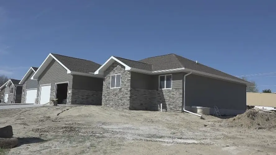 High school shop class teacher finishing student's house project