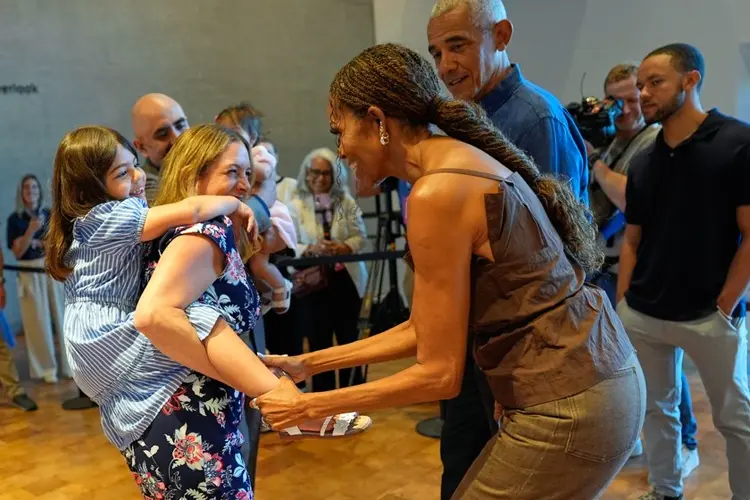 Barack and Michelle Obama surprise first visitors to newly opened presidential center