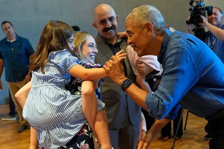 Barack and Michelle Obama surprise first visitors to newly opened presidential center