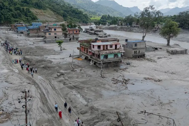 Death toll from flash floods rises with rescuers in Nepal and China working to find hundreds missing