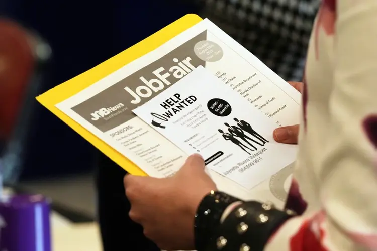 The number of Americans applying for jobless aid slips to 203,000 as layoffs remain low