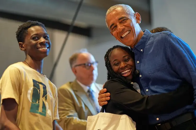 Barack and Michelle Obama surprise first visitors to newly opened presidential center