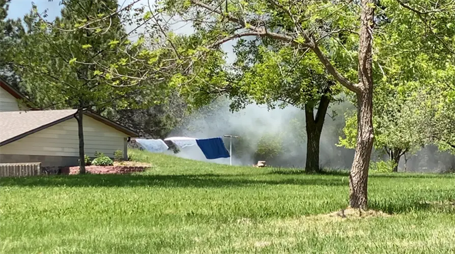 No injuries as trees and brush catch fire in Kearney backyard