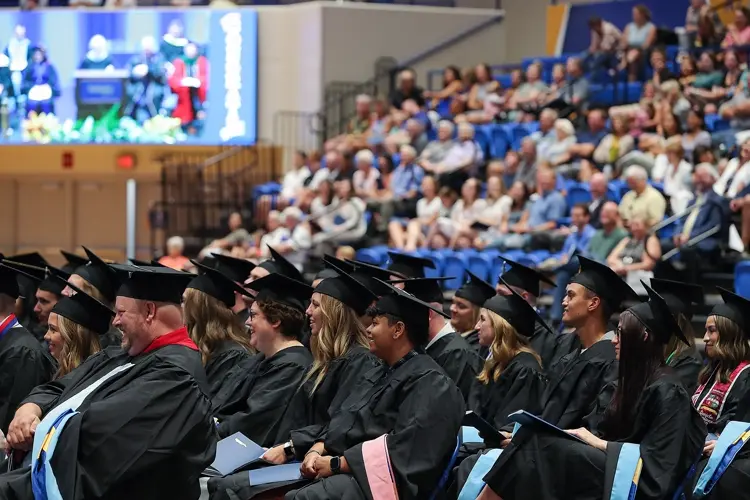 Graduate Mackenzie Hagemeister, Czech colleagues speaking at UNK commencement
