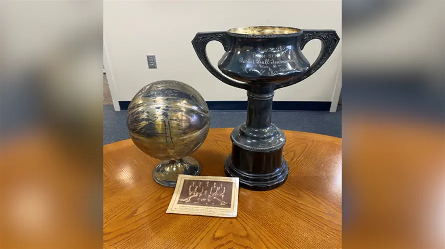 Shelton boys basketball shares photo of 1918 and 1919 state title trophies