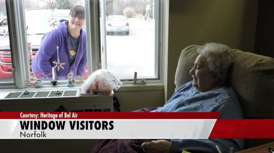 Nursing home allows visitations through courtyard windows