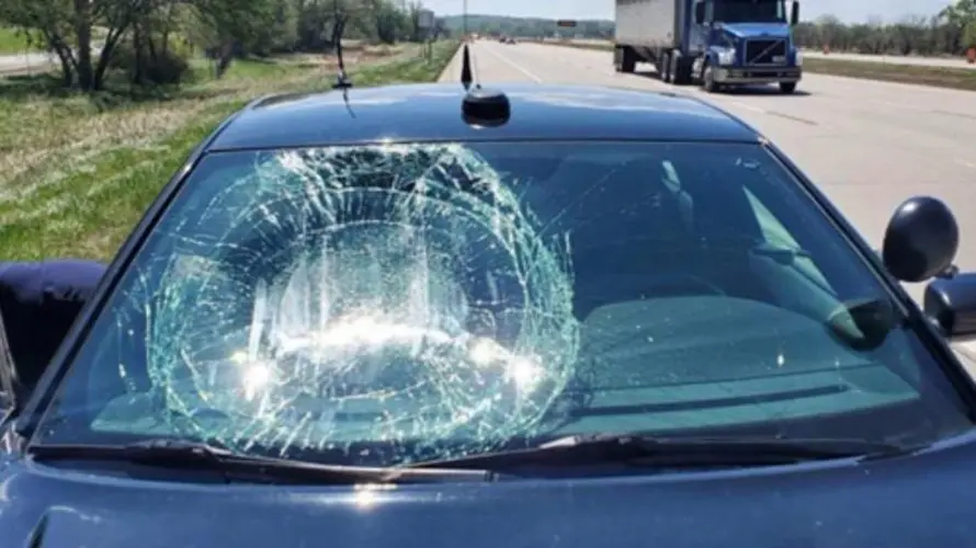 Wind drops construction barrel on state patrol investigator's car