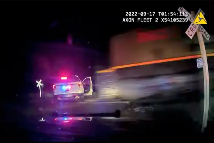 Colorado police release video of police car with suspect inside hit by a train