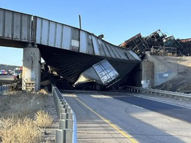 Truck driver killed when train derailment collapses Colorado bridge, spilling coal cars onto highway