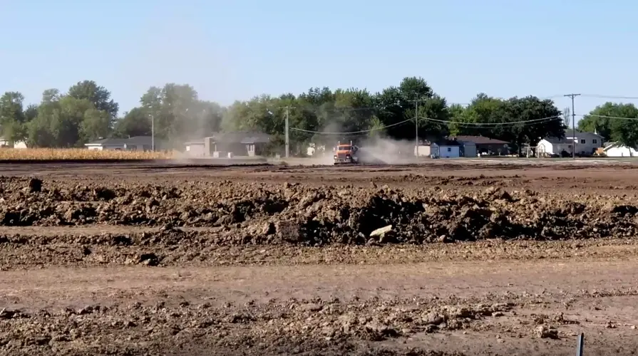 Trucks begin hauling tons of dirt to new elementary school site in east Beatrice