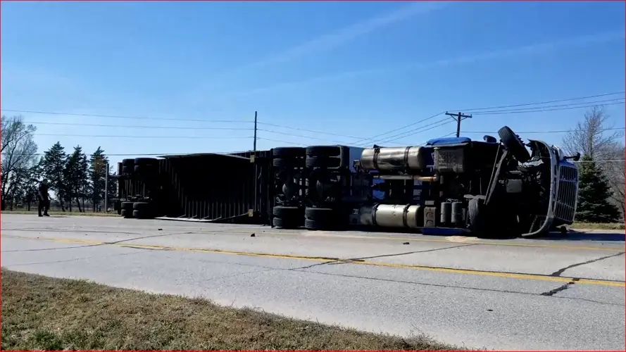 Truck fails to make highway curve, overturns