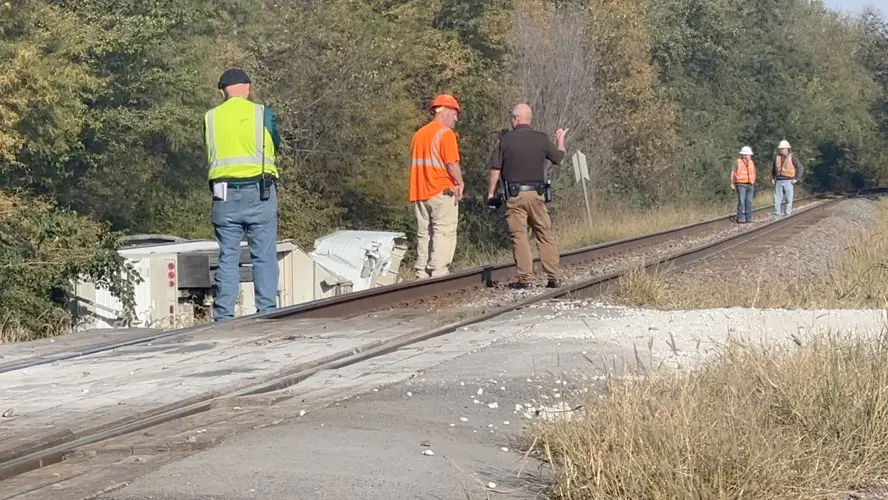 Train hits grain hauler at tricky intersection