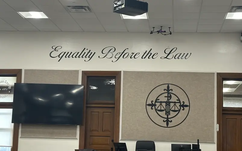 May appeals felony weapons charge to state court of appeals; District Court sentencing postponed