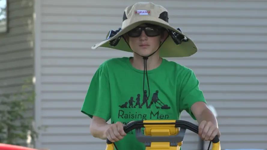 Kearney kid mowing for those in need