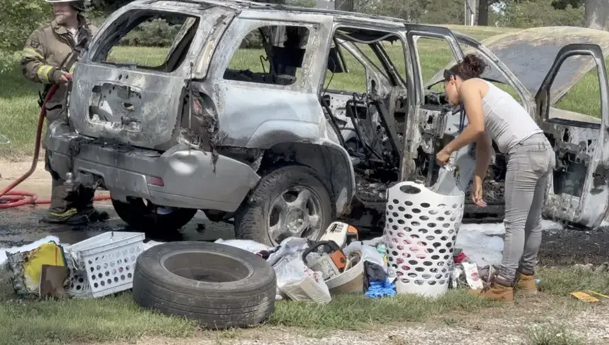 Mujer de Auburn saca sus pertenencias de un auto en llamas