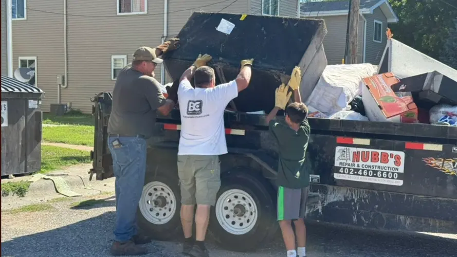 Local Leaders Help Clean Up Trash at Hastings Apartment Complex